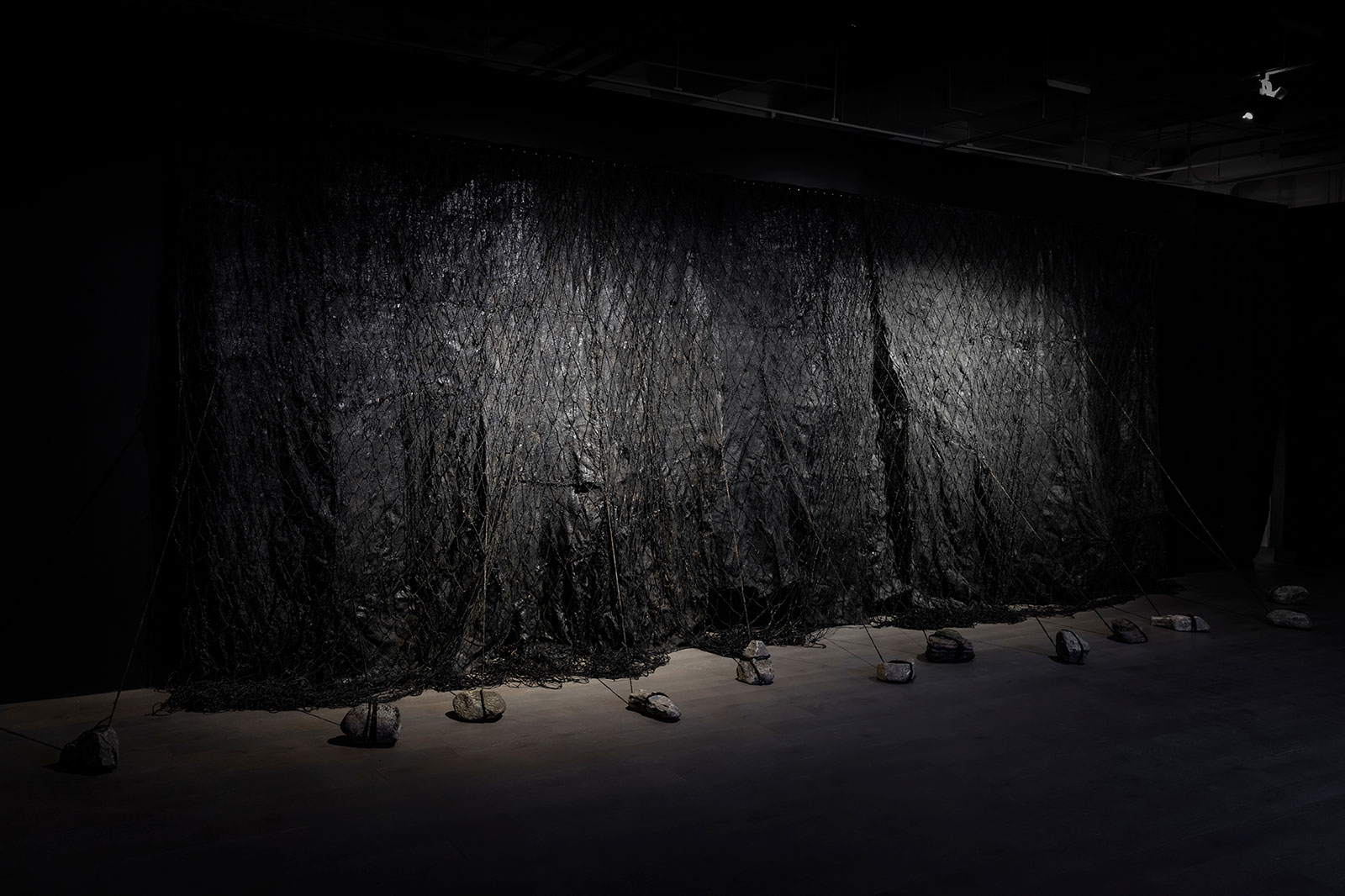 Nicole Collins, Apeiron, 2018 (installation detail), microcrystalline wax, charcoal, burlap, jute, coir, stone, dimensions variable.